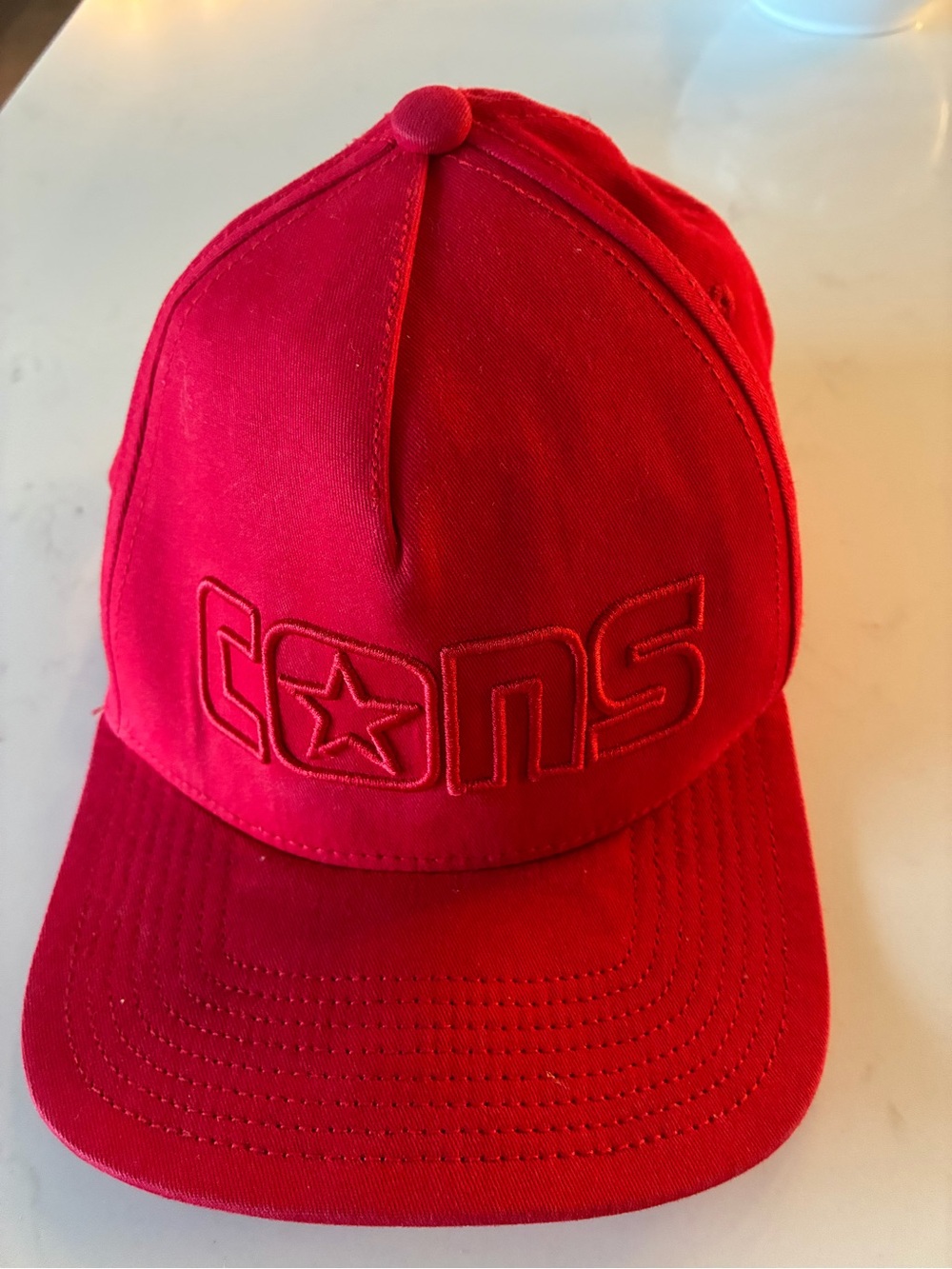 Converse Cons flat-brim baseball cap featuring a tonal embroidered "CONS" logo